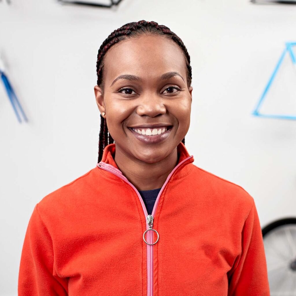 portrait of a woman with glasses in bike shop RBN8CF4